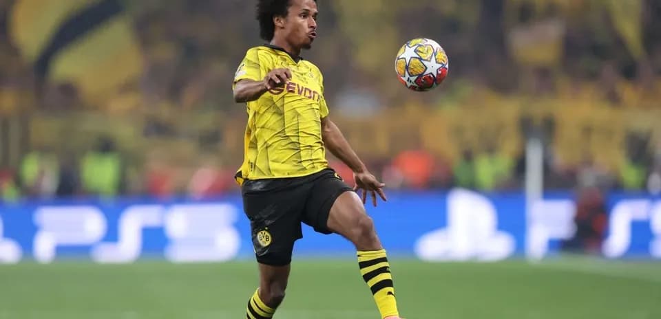 Player in Borussia Dortmund kit controlling the ball