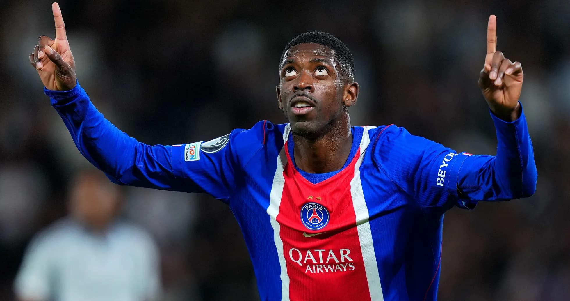 Player celebrating goal in PSG jersey during match