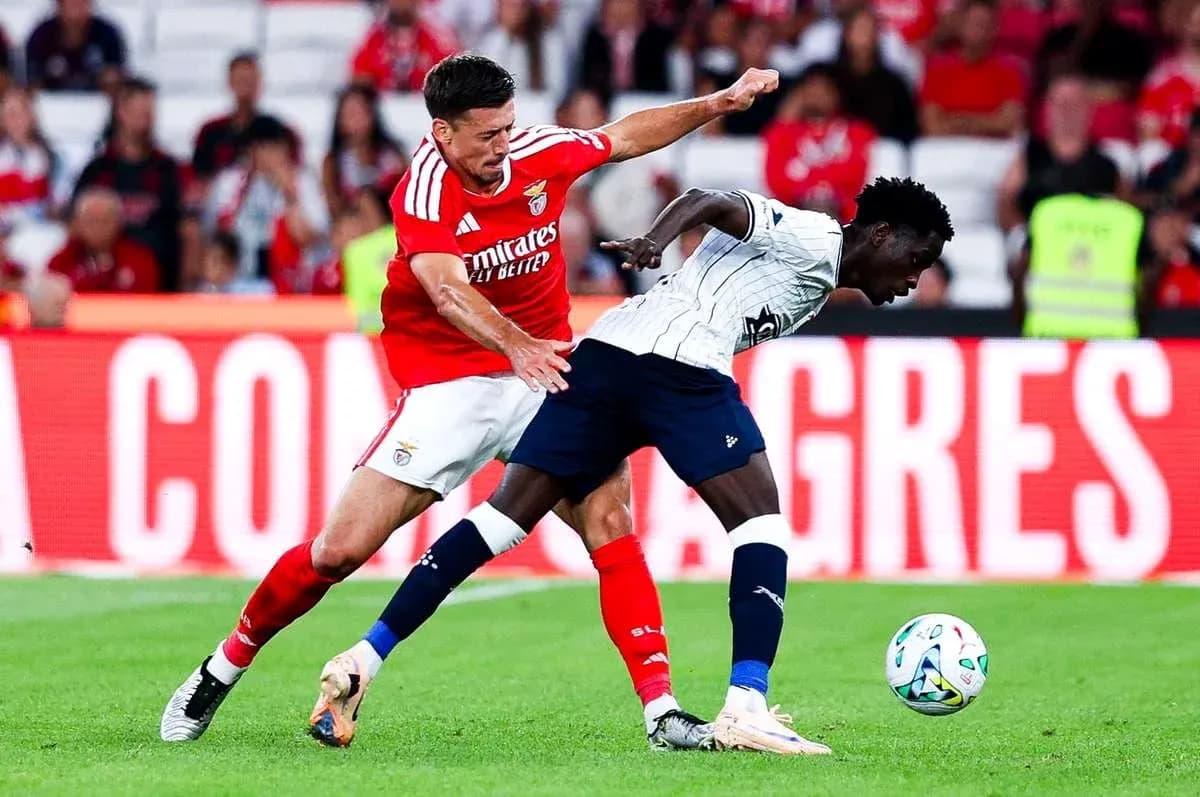 Benfica player tackling Aarhus opponent during match