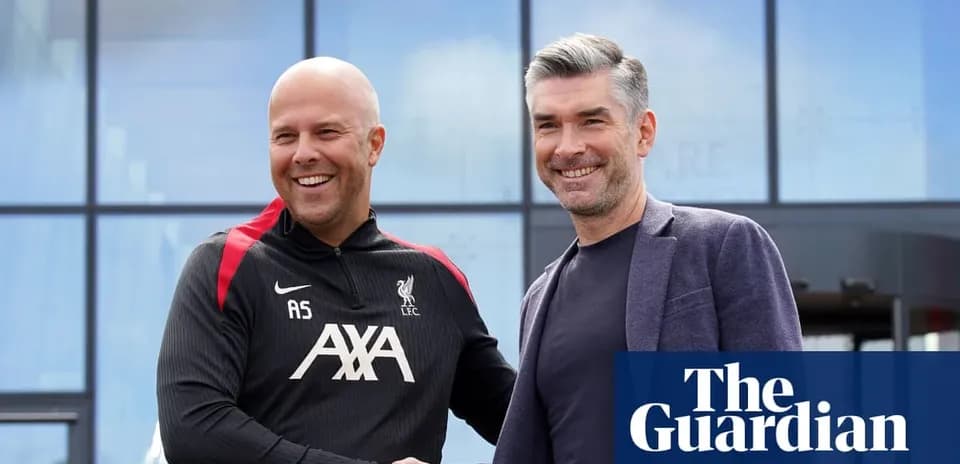 Two coaches shaking hands outside Liverpool training facility