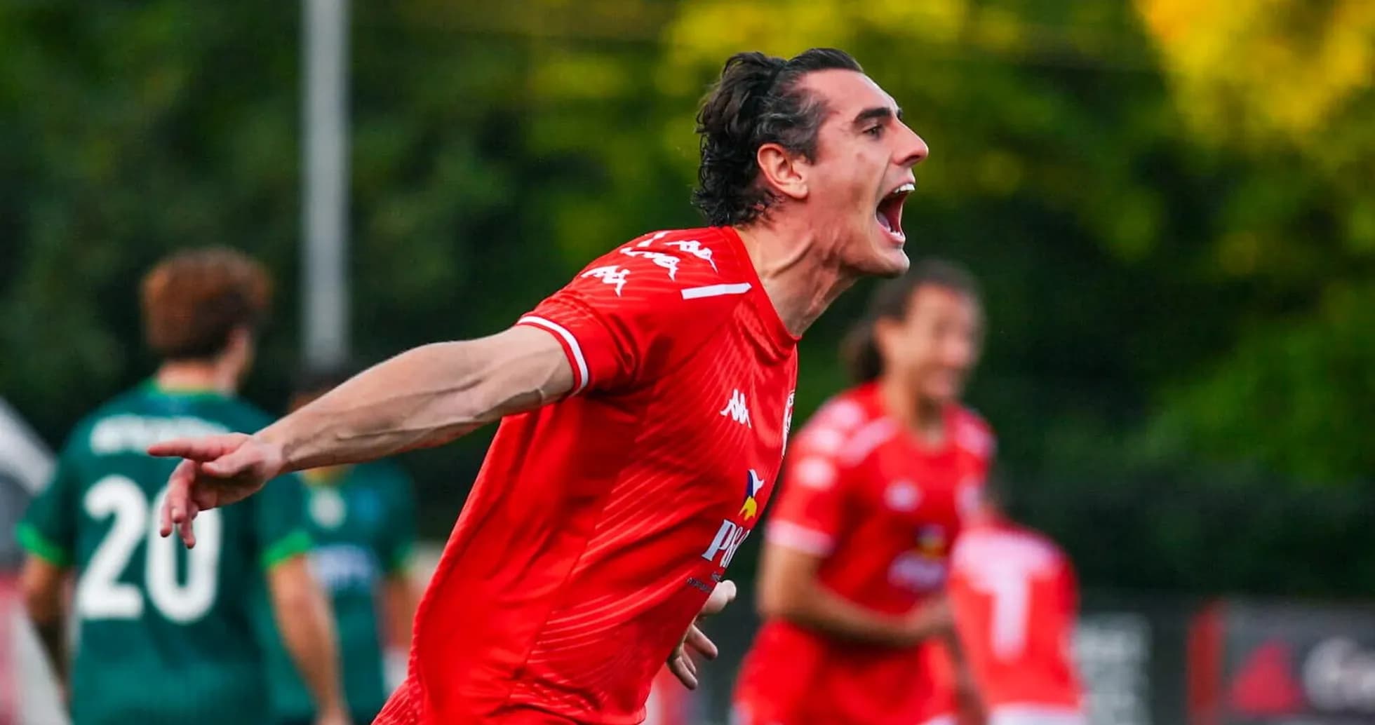 Player celebrating goal in Larne match