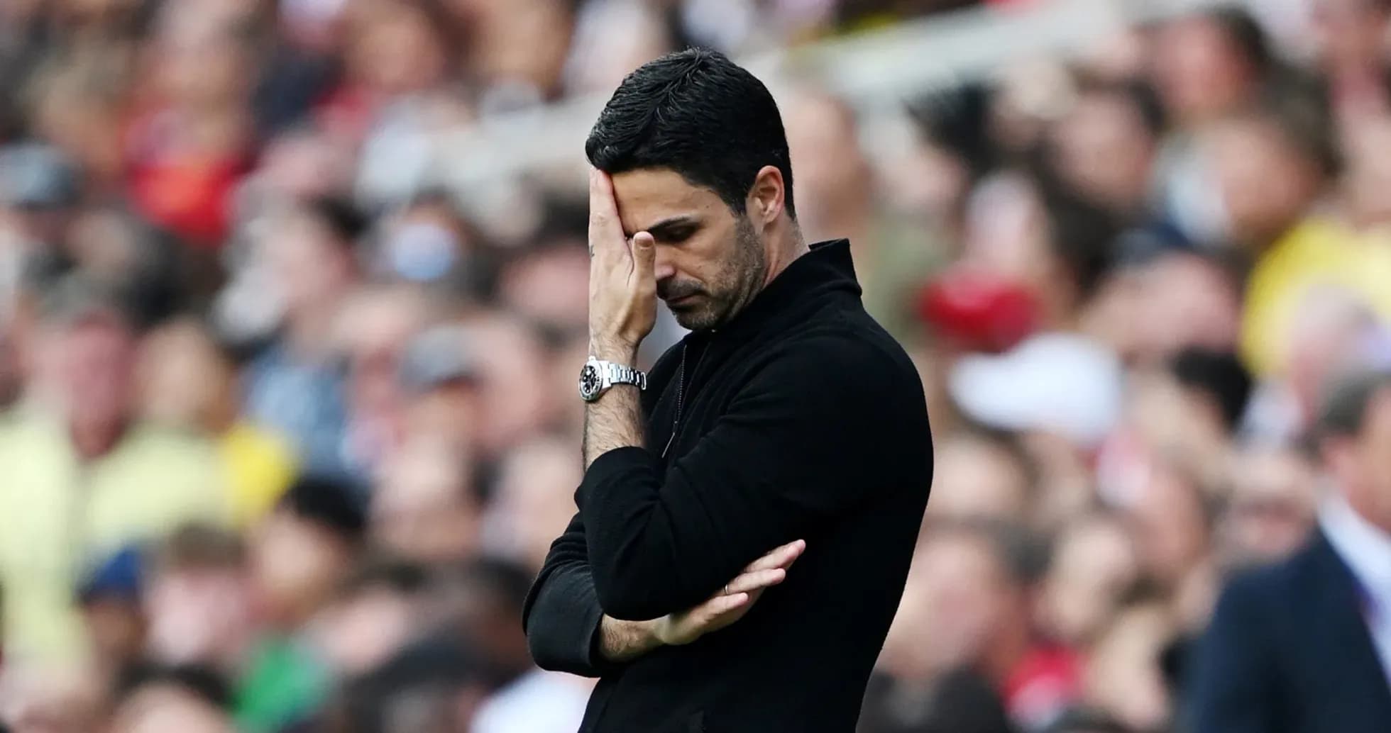 Coach with hand on forehead during match