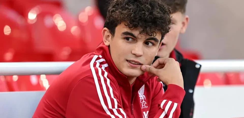Player in Liverpool FC kit sitting on bench