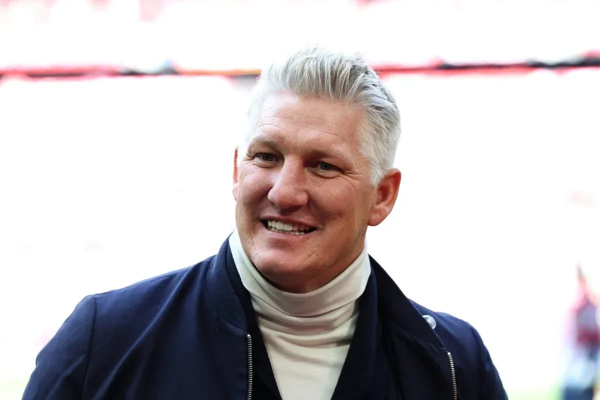Smiling man in a dark jacket and turtleneck