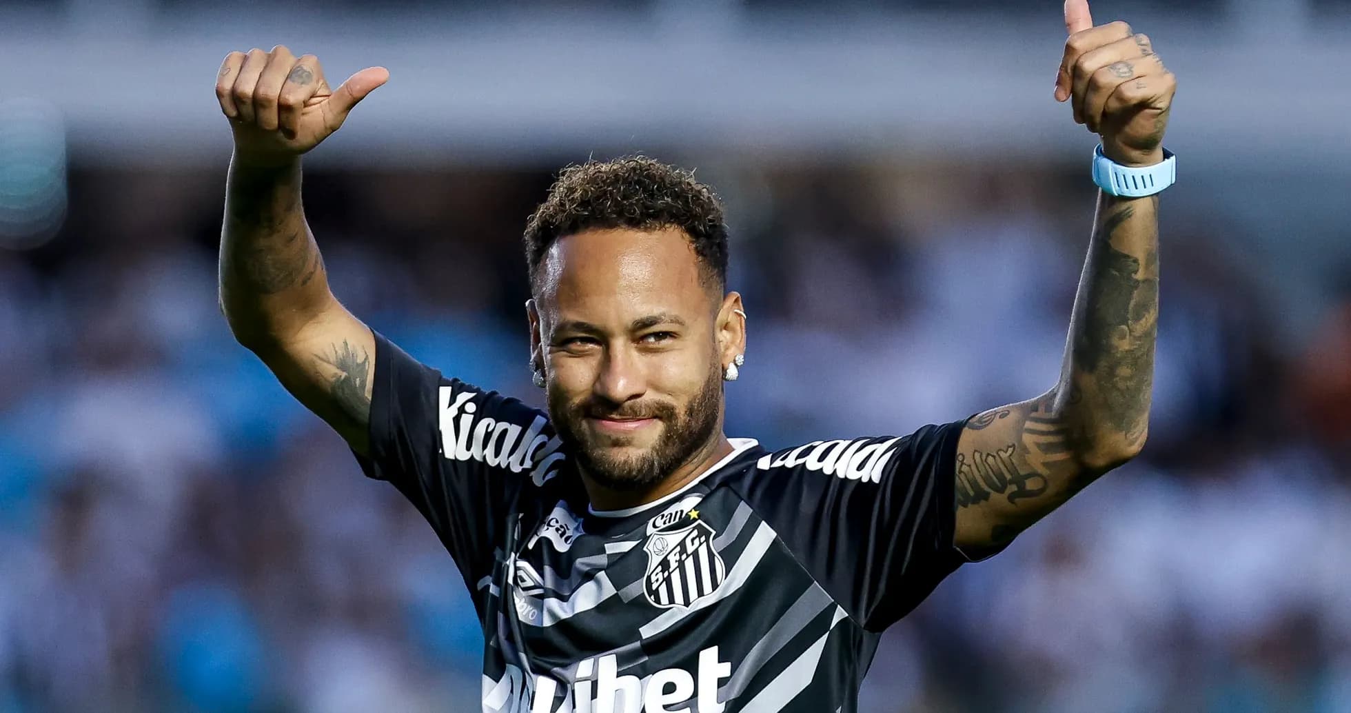 Player celebrating with thumbs up in team jersey