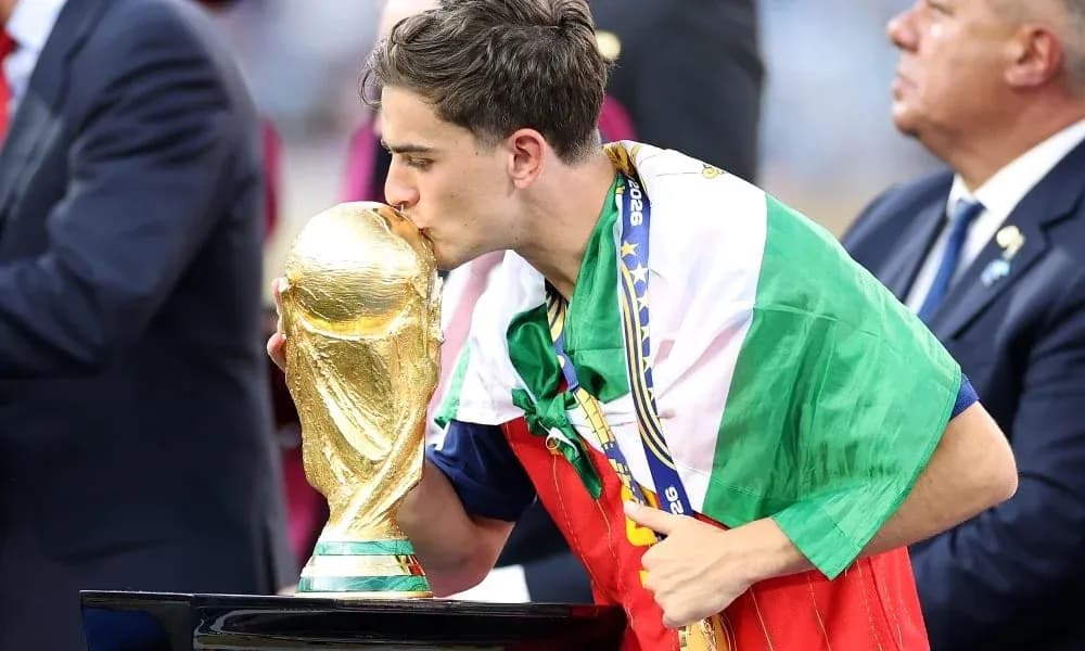 Player kissing the World Cup trophy on stage