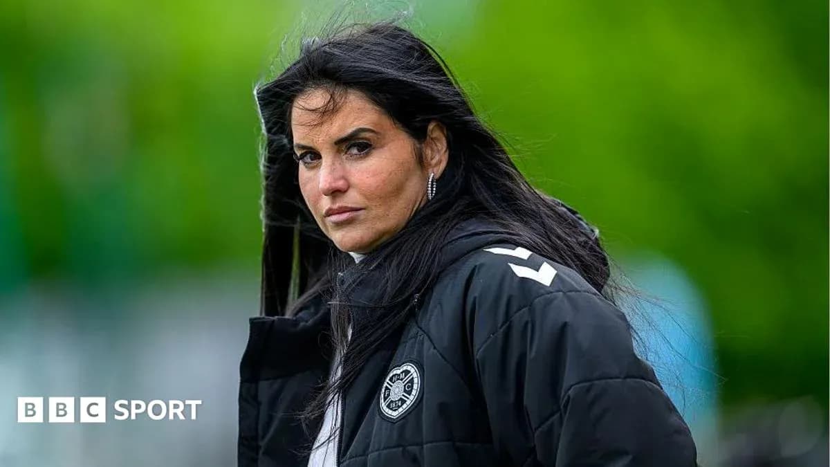 Coach observing training session with serious expression