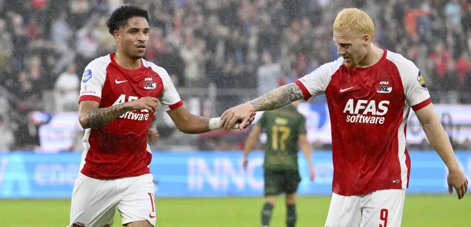 Two AZ Alkmaar players celebrating during a match