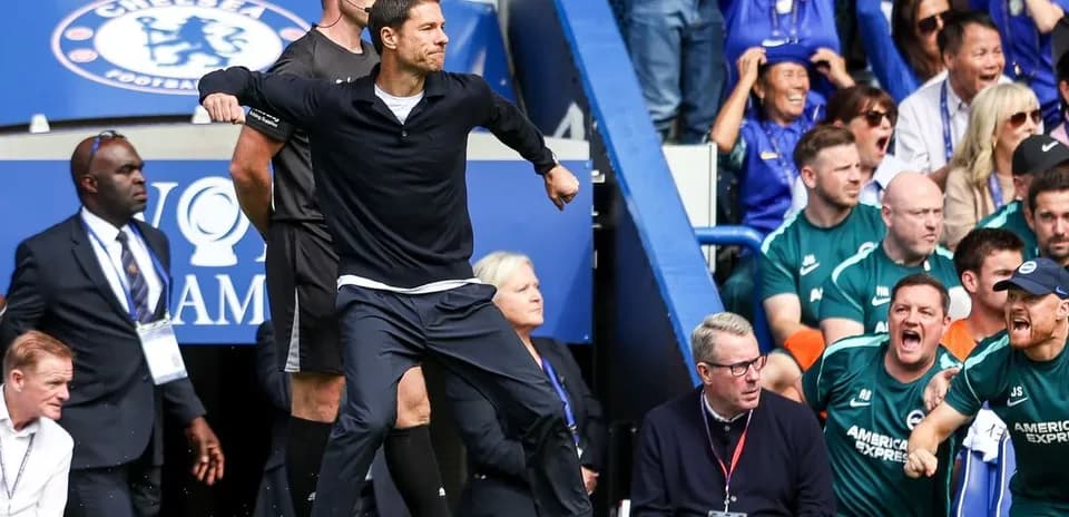 Coach celebrating during match with excited crowd