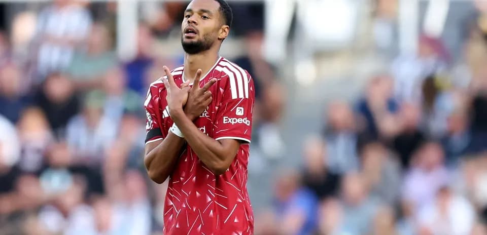 Player gesturing during match, fans in background