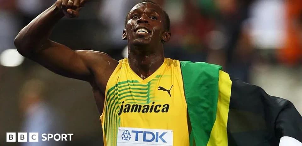 Athlete celebrating victory with Jamaica flag