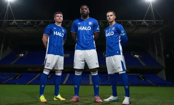 Three players posing in blue Ipswich Town kits