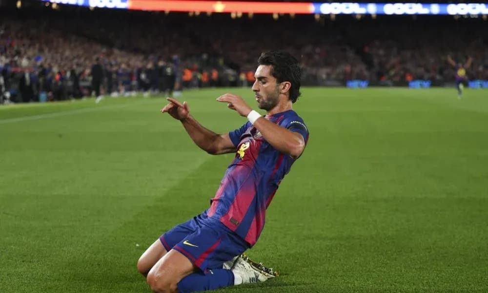 Player celebrating after scoring a goal at Camp Nou