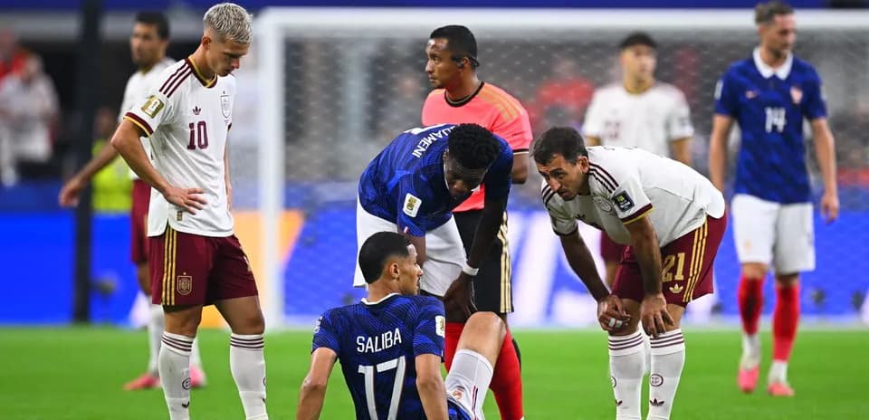 Players attending to injured teammate on field