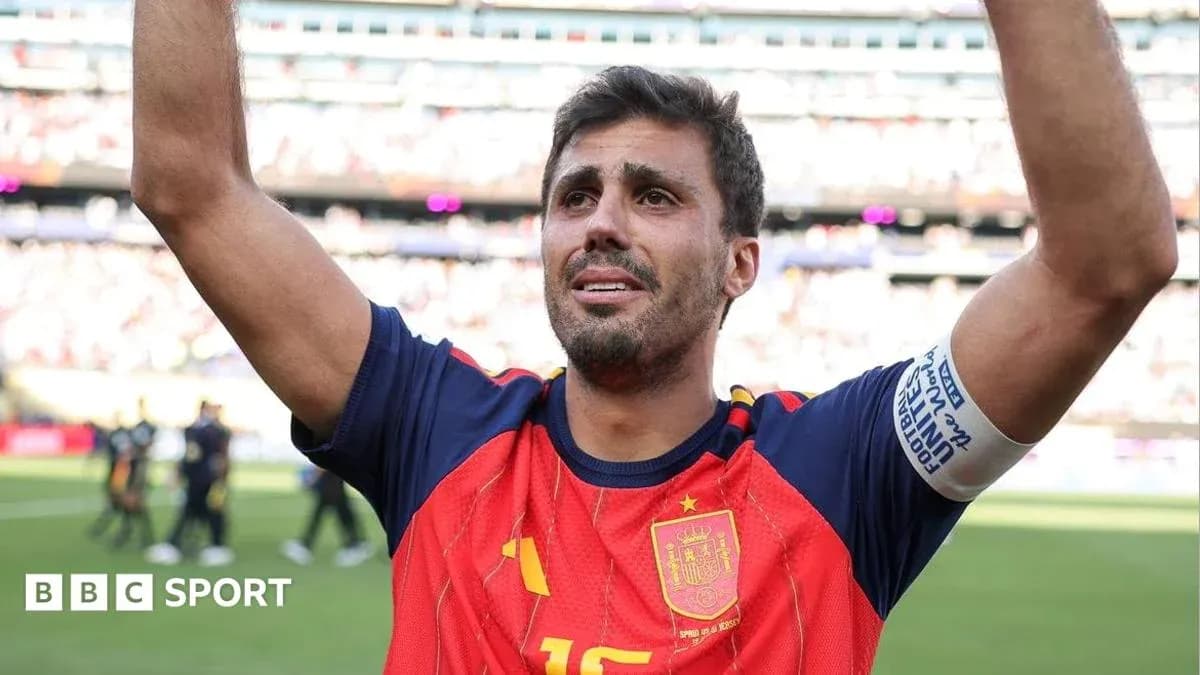Player celebrating with raised arms in Spain jersey