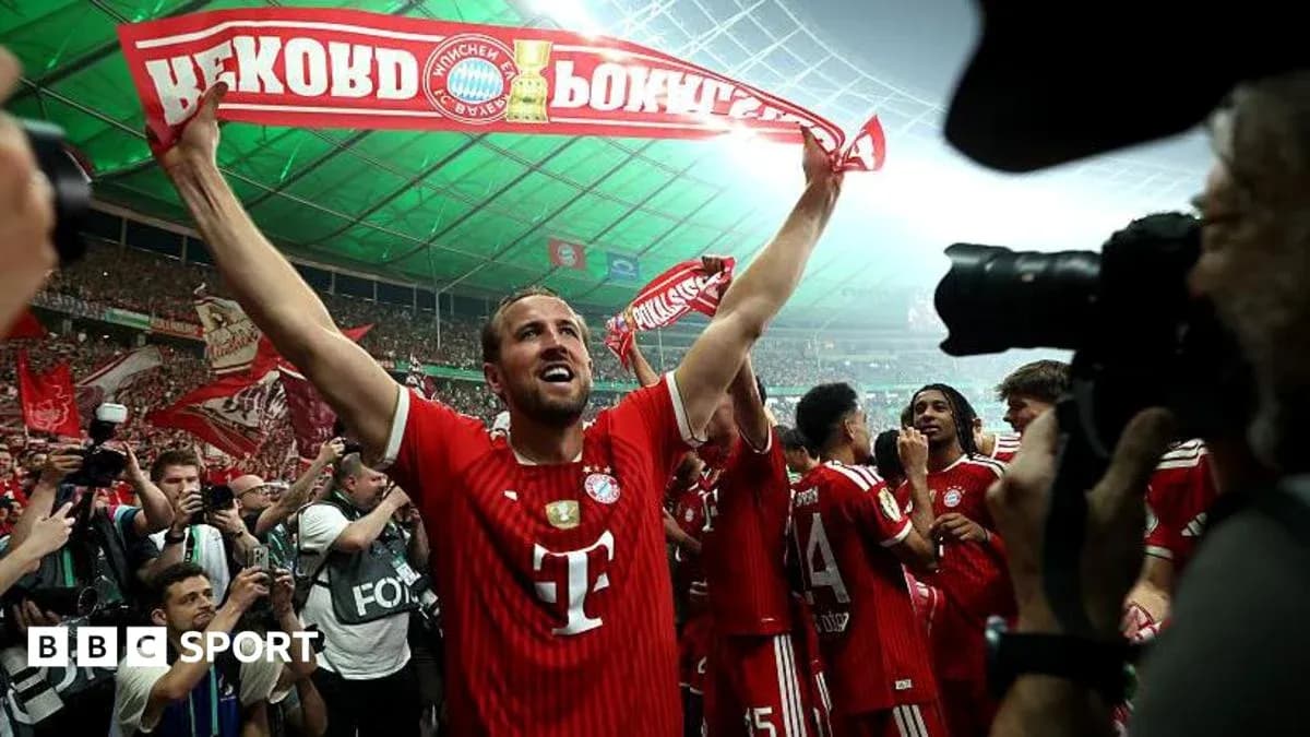 Bayern Munich player celebrating with fans and scarf