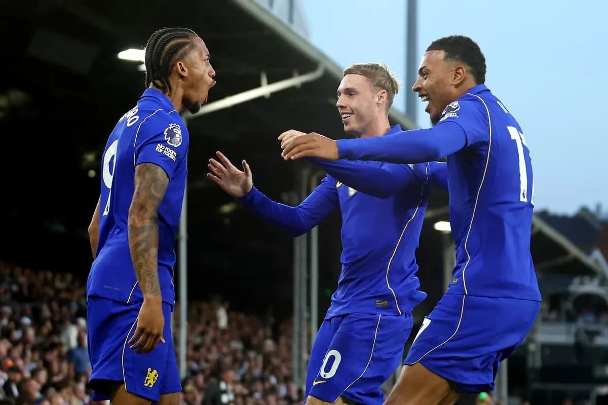 Three players celebrating a goal in blue jerseys