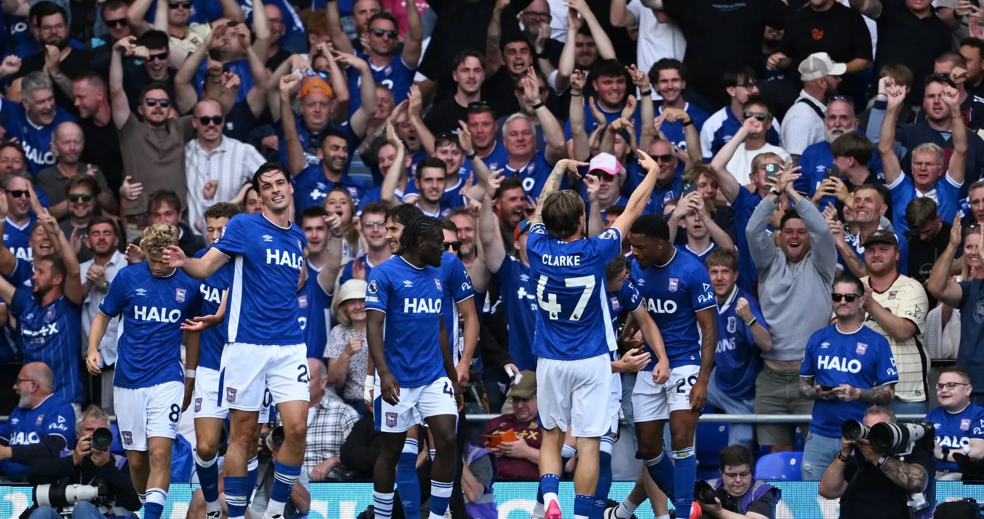 Ipswich players celebrating a goal with fans