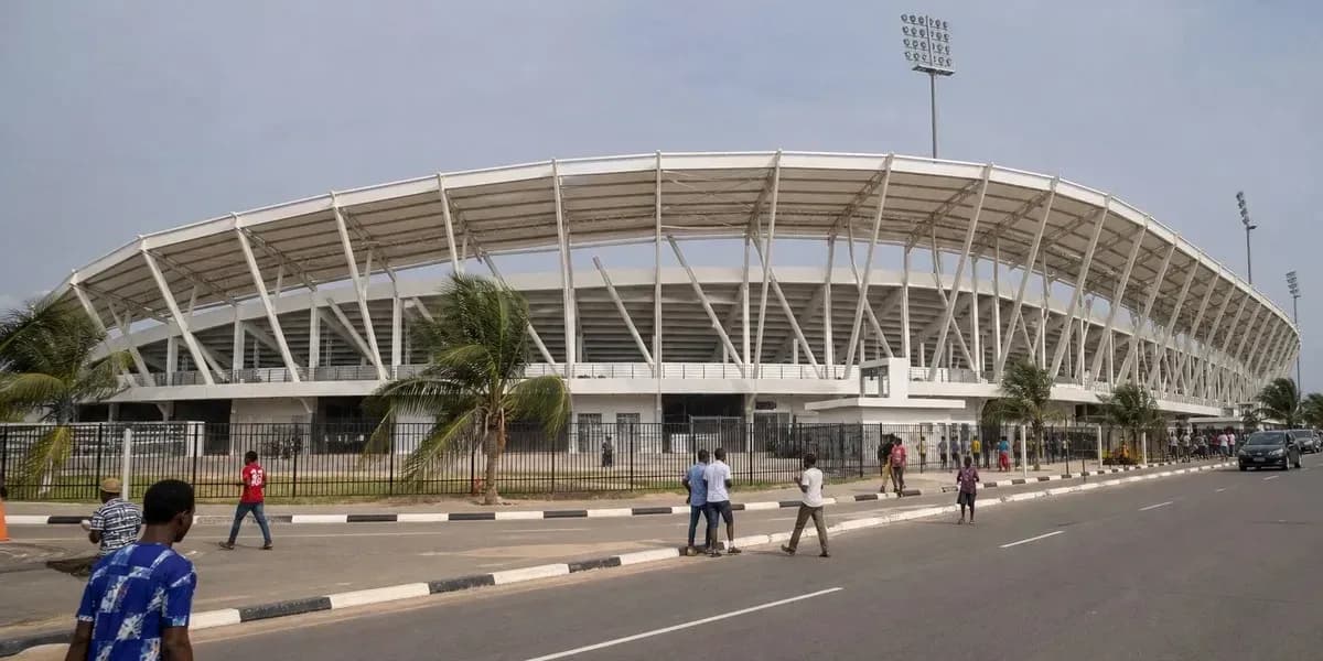 Exterior view of a stadium with pedestrians nearby