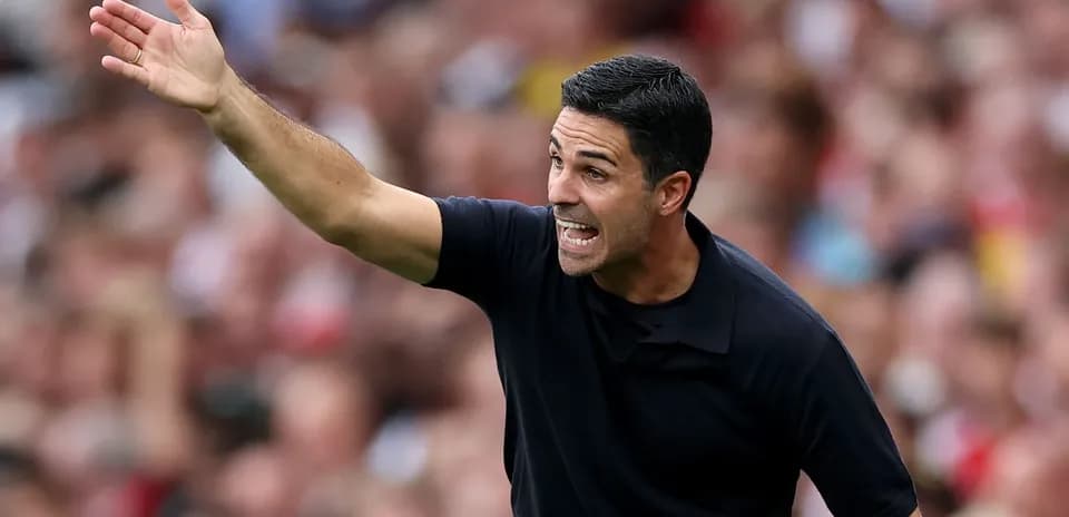 Manager gesturing during a match on the sidelines