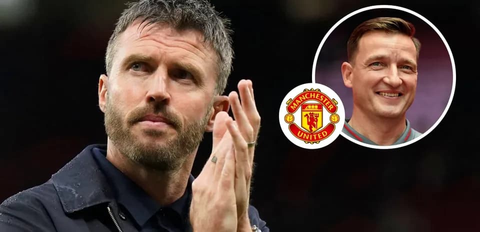 Manchester United coach applauding with another staff member