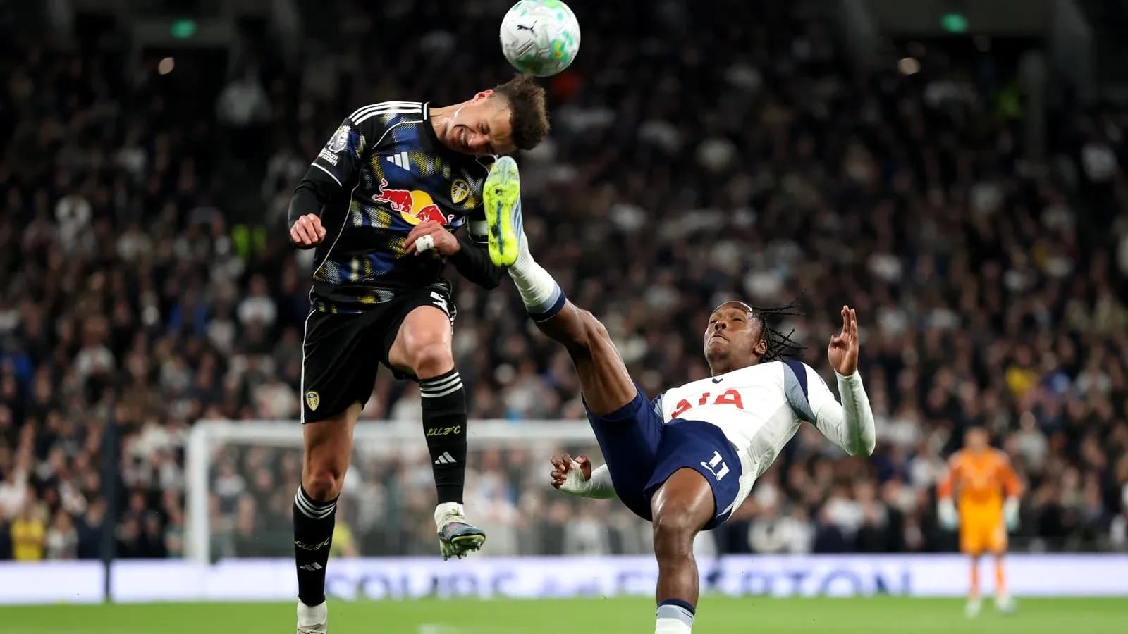 Goalkeeper and player colliding during match action