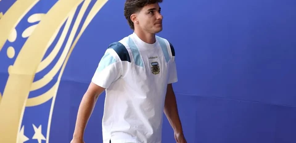 Player walking in front of blue backdrop