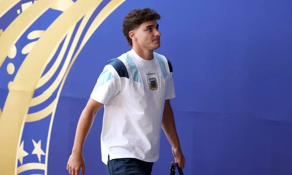Player walking in front of blue backdrop