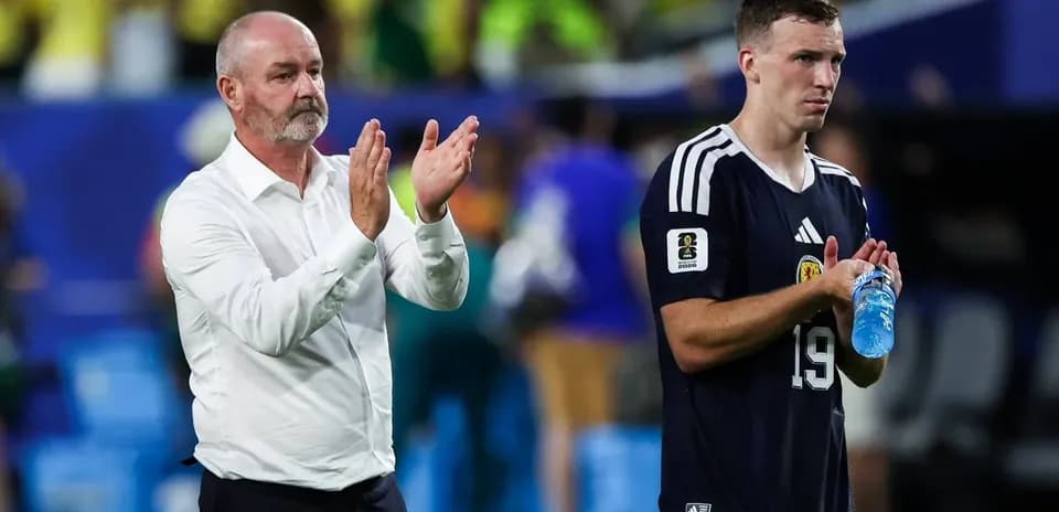 Coach and player applauding fans after match