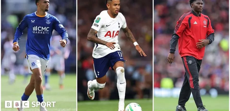 Three football players in club kits on field