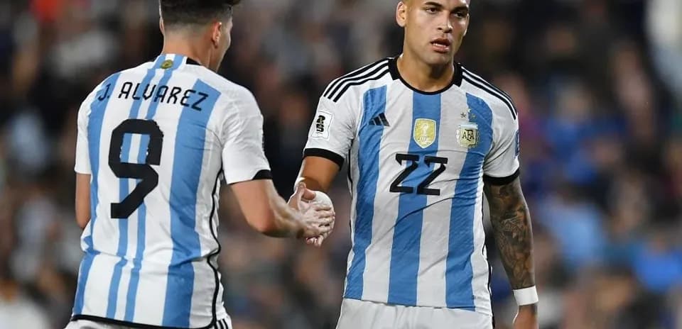 Two Argentina players shaking hands during match