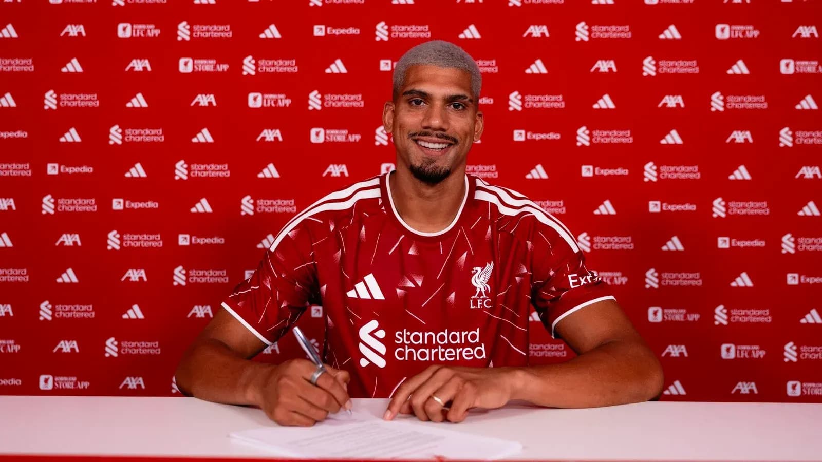 Player signing contract at Liverpool FC announcement