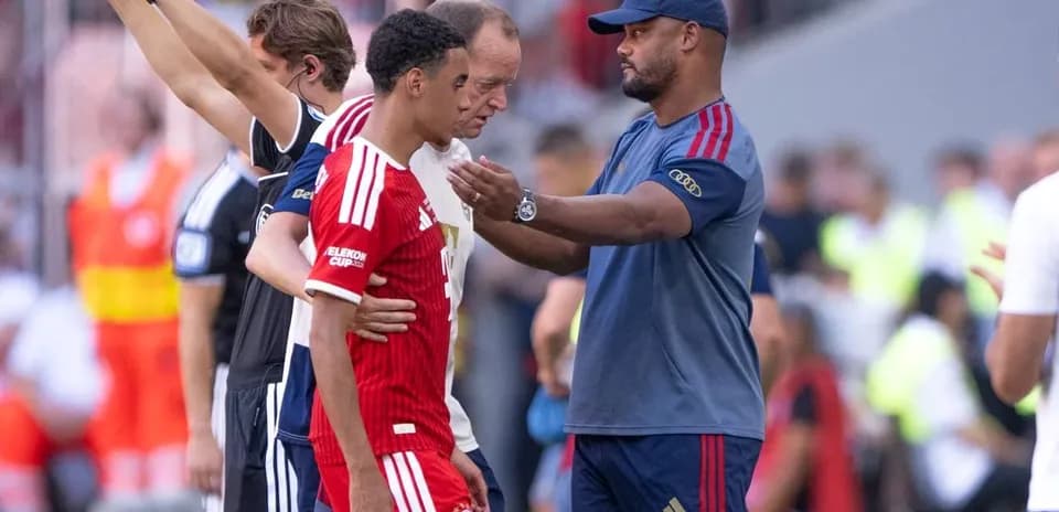 Coach interacting with player during match substitution