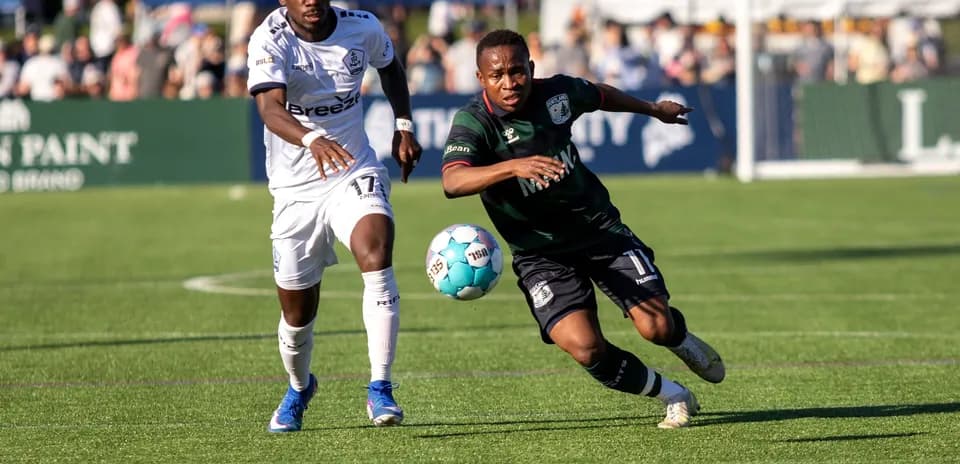 Two players competing for the ball in match