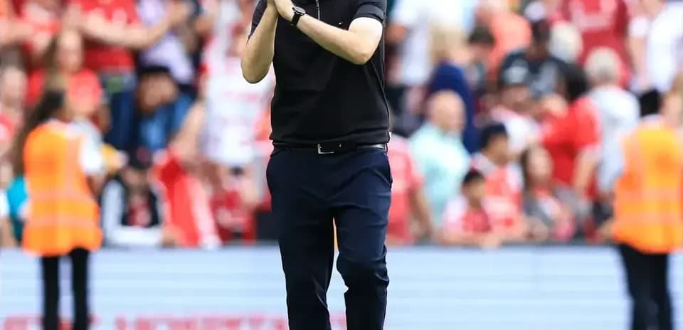 Coach applauding fans after a match