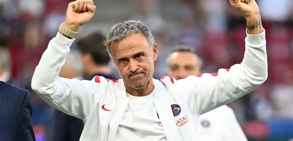 Coach celebrating with raised arms after match