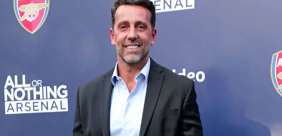Man in suit smiling at promotional event