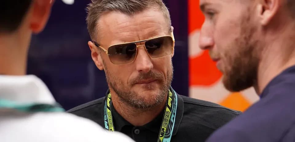 Man in sunglasses talking with two others