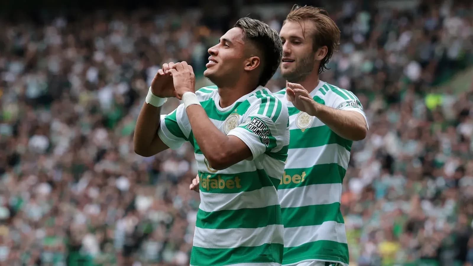 Celtic players celebrating a goal during match