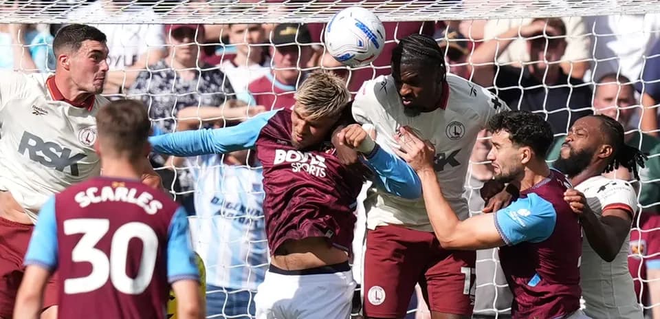 Players contesting a header in front of the goal