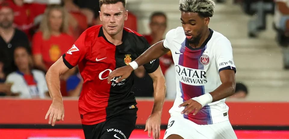Players from Mallorca and PSG competing for the ball