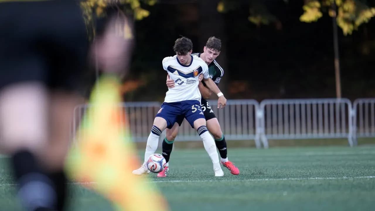 Two players competing for the ball in football