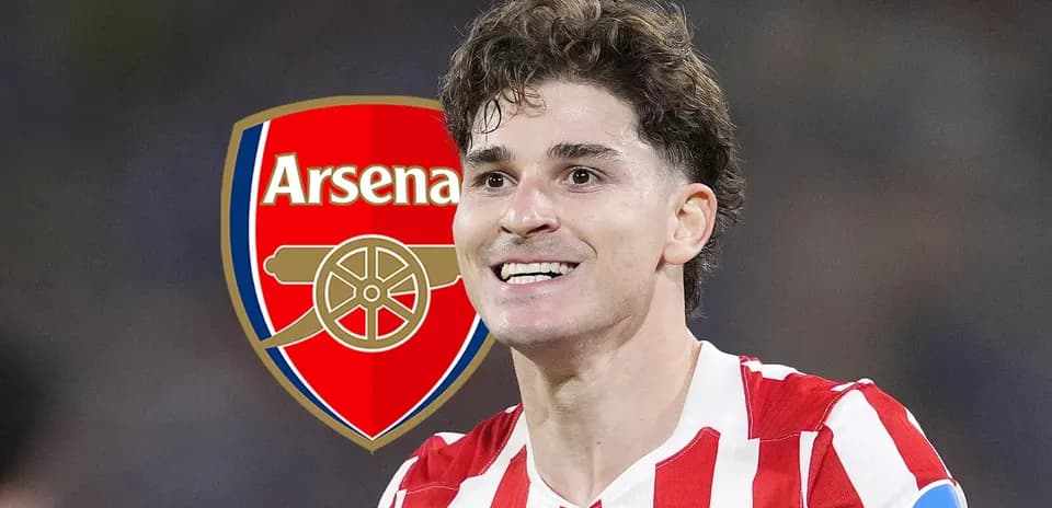 Player celebrating with Arsenal logo in background