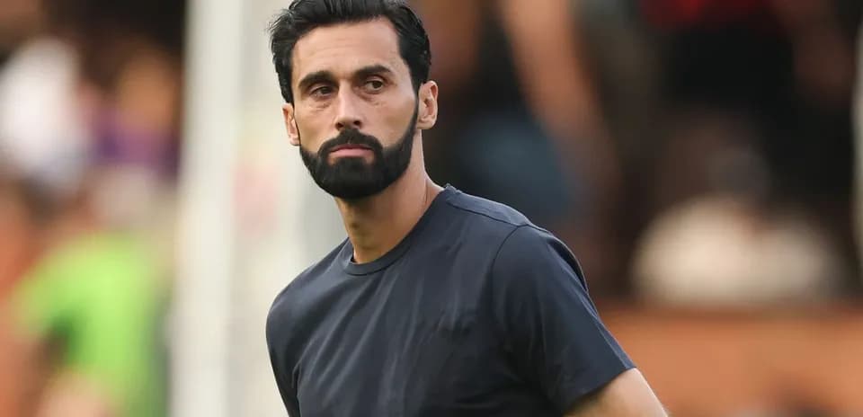 Man in dark shirt observing a match