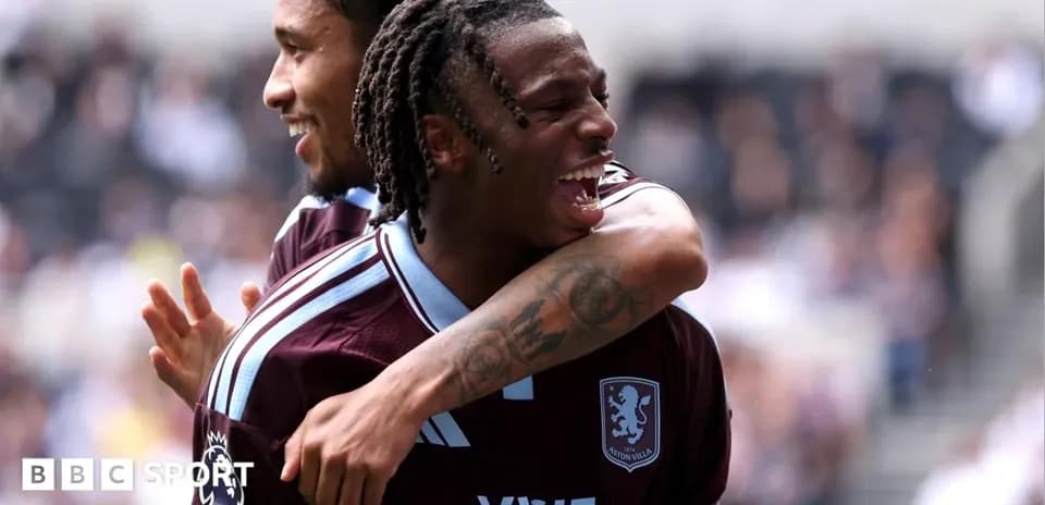 Two Aston Villa players celebrating a goal together