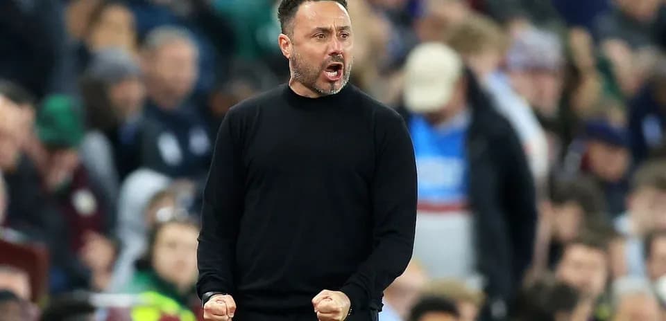 Coach celebrating passionately on the sidelines