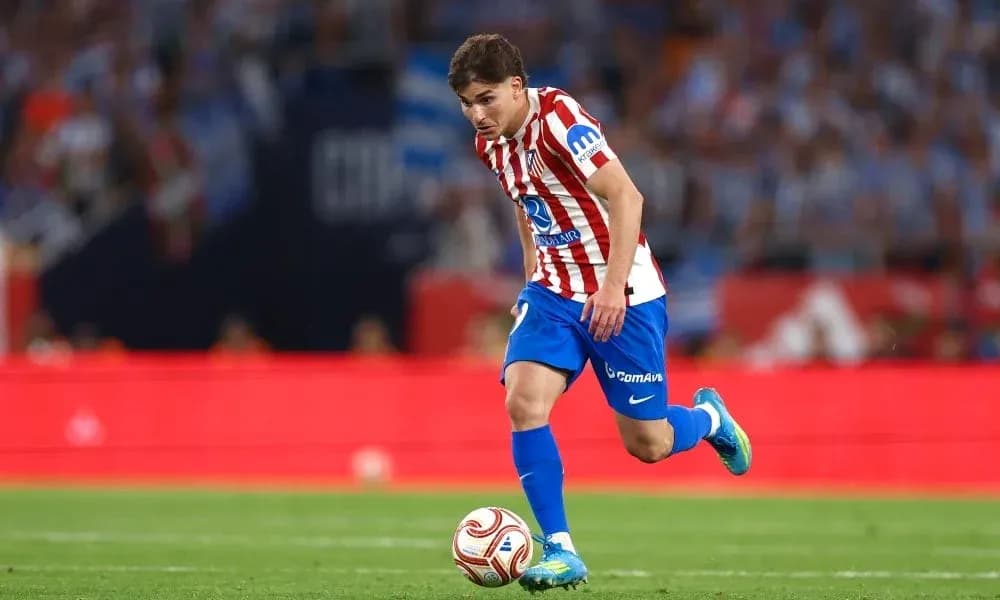 Atletico Madrid player dribbling the ball during match