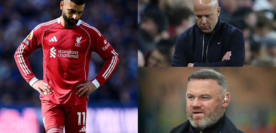 Liverpool player looking down, two coaches observing match