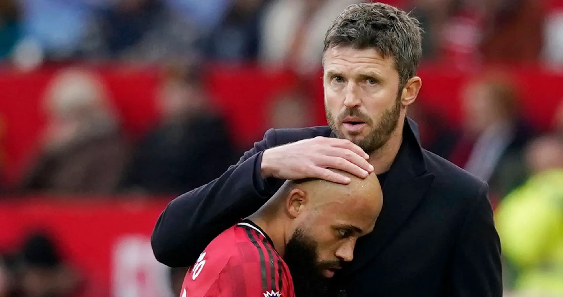 Coach comforting player on the sidelines