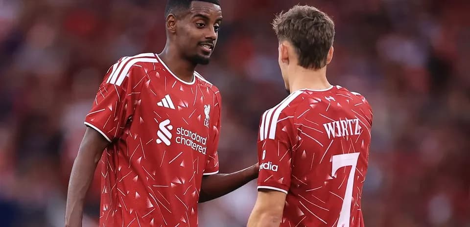Two Liverpool players discussing during a match